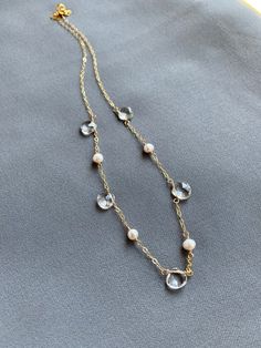 🌟🌟🌟A perfect balance in harmony - pearls and clear quartz.  This necklace lies delicately at the base of the throat.  Makes a great gift for your bridesmaids or yourself.+ Picture #2 was a collection made for a bridal party.+ Quartz. Freshwater Pearls. Gold Fill Chain & Lobster Clasp.+ Necklace measures 17 inches (43.18 cm) in length.+ Necklace takes 1 business day to ship.+ Your jewelry will come in a jewelry box, tied with our a ribbon.+ Listing is for one (1) necklace.+ Bridal discount Elegant White Crystal Necklace With Pearl Chain, Elegant White Crystal Necklaces With Pearl Drop, Elegant White Crystal Necklace With Pearl Drop, Elegant Crystal Necklace With Pearl Drop As Gift, Elegant Pearl Drop Crystal Necklace Gift, Elegant Faceted Pearl Necklace, Delicate Crystal Clavicle Chain Necklaces For Wedding, Clear Pearl Jewelry As A Gift, Pearl Necklaces With Faceted Detail As Gift