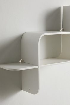 a white shelf with two open shelves on it