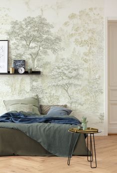 a bed sitting under a tree wallpaper next to a table with a potted plant on it