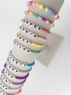 one colorful beaded name bracelet bracelets are made on a durable stretch elastic cord please refer to our sizing guide before purchasing Small Beaded Bracelets Rainbow, Name Beaded Bracelet, Friendship Bracelets Names, Everyday Colorful Beaded Stretch Bracelet, Adjustable Name Bracelet With Colorful Beads, Cute Adjustable Letter Beads, Colorful Adjustable Letter Beads Jewelry, Flexible Friendship Bracelets With Letter Beads, Trendy Stretch Bracelet With Letter And Heishi Beads