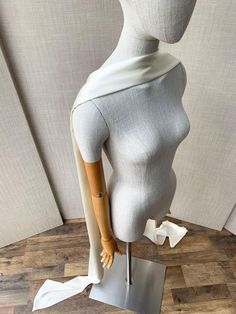 a white mannequin with wooden arms and legs