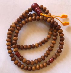 This small sandal wood mala has three traditional decoration beads and guru beads. It is from Nepal and nice and beautiful mala. it is 11 inches long mala. Holistic Wooden Beads Mala For Festivals, Brown Mala For Healing And Festivals, Traditional Wooden Beads Necklace For Healing, Holistic Wooden Beads Mala For Rituals, Holistic Wooden Mala For Rituals, Holistic Brown Mala With Wooden Beads, Traditional Wooden Beads Mala As Gift, Traditional Wooden Beaded Bracelets, Brown Wooden Beads Spiritual Mala