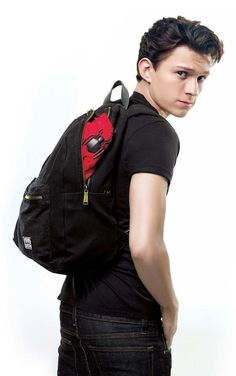 a young man is wearing a backpack with a deadpool on it's back