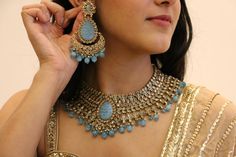 Strike a perfect balance between style and elegance in this stunning blue bridal jewelry set! Classic handcrafted polki jewelry set will be a pleasure to adorn.  The set includes a necklace, a maang tika and a pair of beautiful chandbali earrings.  Details: Necklace Width-3 Inches Earrings Length-3.75 Inches Earrings Width-2 Inches Weight of Each Earring-29 gms Tika Length-5 Inches All products are manufactured using traditional skills from our rich heritage of crafts.  The process of these craf Blue Chandbali Bridal Necklace For Wedding, Traditional Blue Jewelry For Wedding, Blue Temple Jewelry For Wedding, Blue Hand Set Kundan Necklace For Wedding, Blue Jewelry With Stone Work For Reception, Blue Chandbali Kundan Necklace For Wedding, Blue Meenakari Bridal Necklace In Temple Jewelry Style, Blue Temple Jewelry Bridal Necklace With Meenakari, Blue Hand Set Bridal Necklace For Reception