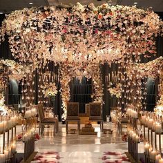 the aisle is decorated with flowers and candles for an elegant wedding or special event venue