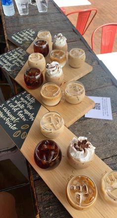 there are many desserts on the wooden trays that are ready to be eaten