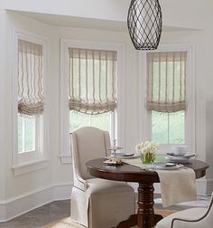 the dining room table is set with four chairs, and there are no people around it