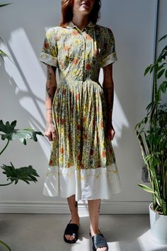 Sixties "Tall Over Five Seven Shops" Floral Garden Party Cotton Dress. Pleated Skirt. Semi-Sheer. Unlined. Peter Pan Collar. Button Closure in Front. White Collar, Sleeve Cuffs, and Skirt Hem With Yellow Soutache Embroidery. Belt Loops. No Content Label No Size Tag Excellent Vintage Condition - General Wear, Belt MIA All Measurements Taken Flat Pit to Pit-18" Waist-12.5" Hips-free Shoulder to Shoulder-13.5" Shoulder to Hem-46" All Sales Are Final. We have taken the time to note all size measurem A-line Midi Dress With Buttons For Garden Party, Summer Dresses With Buttons For Garden Party, Fitted Midi Dress With Buttons For Garden Party, Fitted Button Dress For Garden Party, Summer Garden Party Dress With Buttons, Summer Garden Party Dresses With Buttons, Summer Vintage A-line Pleated Dress, Knee-length Button Dress For Garden Party, Vintage A-line Midi Dress For Garden Party