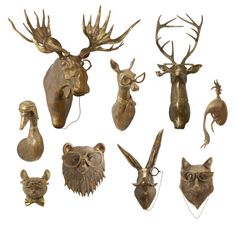 an assortment of animal heads are shown in gold and bronze metal, each with different types of headdress