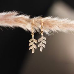 LEAF EARRINGS DESCRIPTION A simple yet stunning pair of elegant leaf dangles to grace your ears --pairs beautiful with a little black dress, or these days your favourite working-from-home loungewear. DETAILS * 20k gold or silver-plated metal; nickel-free. * Approximate pendant size: 25 mm. * Earring drop length: approximately 1.5 inches. * All earrings are final sale. * Designed and made in Ottawa, Ontario, Canada. NON-REFUNDABLE ITEM Please note that all earrings are non-refundable due to hygie Elegant Leaf Shaped Earrings As Gift, Elegant Leaf-shaped Earrings For Gift, Elegant Leaf-shaped Earrings, Delicate Nickel-free Earrings As Gift For Her, Everyday Leaf-shaped Jewelry With Matching Earrings, Elegant Leaf-shaped Jewelry With Matching Earrings, Elegant Single Leaf Earring, Elegant Rose Gold Leaf Jewelry, Elegant Rose Gold Leaf-shaped Jewelry