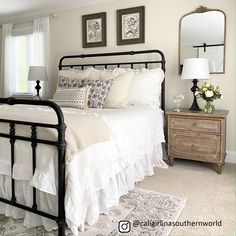 a bedroom with white bedding and pillows