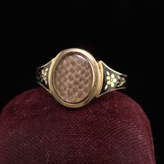 Beautiful Antique Victorian 18K Yellow Gold Enamel Hair Mourning Ring. This amazing ring has pristine enameling and the hair is still intact inside the glass. It has flower designs on the side of the ring without any damage which is rare. The inside of the ring is hallmarked.Item #R0926Metal: 18K Yellow Gold.Weight: 4 GramsRing Size: 8Measurements: Top measures 13 mm wide and band measures 2.8 mm wide.Measurement from finger to top of ring: 3.75  mmLayaway: For your convenience, we will be happy Elegant Yellow Gold Enamel Signet Ring, Victorian Oval Yellow Gold Enamel Ring, Victorian Oval Enamel Ring For Anniversary, Antique Yellow Gold Signet Ring With Black Enamel, Antique Yellow Gold Enamel Wedding Ring, Antique Black Enamel Signet Ring, Heirloom Black Enamel Signet Ring, Vintage Yellow Gold Enamel Rings, Vintage Black Enamel Ring For Anniversary