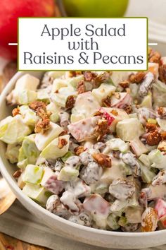 an apple salad with raisins and pecans in a white bowl on a table