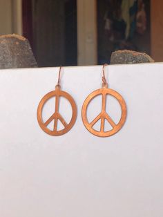 Vintage copper stampings from the 1970s in a peace sign symbol with Pure copper ear hooks hypoallergenic Earrings 2 x 1.5 inches Comes in recycled gift box Carbon neutral shipping Ultra Lightweight Hypoallergenic 100% Ethically Sourced Shop All Earrings: https://www.etsy.com/shop/heatherstonejewelry?section_id=27418141 Peace Sign Earrings Copper Vintage 1970s Stampings Copper Peace Hippie Era Vintage Earrings Hoop Copper Peace Sign Earrings 70s Hoop Earrings Vintage, Vintage Jewelry With Peace Sign As Gift, Vintage Jewelry With Peace Sign For Gift, Peace Sign Earrings, 1970s Southern Vintage Earrings Jewelry, Peace Earrings Hippie, Peace Sign Symbol, Vintage Peace Sign Jewelry Gift, Peace Sign Jewelry