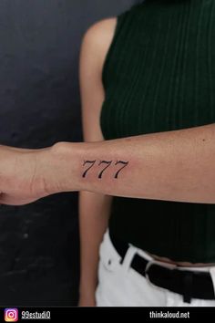 a woman's arm with the number 777 tattooed on her left forearm and wrist