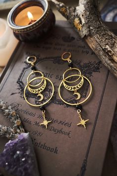 * Stunning statement Moon and Stars earrings which will give your outfit a mystical touch.  * These beautiful dangling earrings have a witchy, bohemian feel to them. * Stainless steel! * The total length of the earrings is approximately 10 cm (aprox 4 inches), hook included.  * They come in a pretty little pouch 🖤 * Matching necklace available: https://www.etsy.com/listing/1736069481/celestial-necklace-with-moon-and-star Witchy Jewelry Bohemian, Witchy Jewelry Inspire Uplift ⭐, Witchy Jewelry Casual, Cheap Witchy Style Jewelry For Gifts, Cheap Witchy Dangle Jewelry, Witchy Jewelry Summer, Snow White Witch, Moon Accessories, Witchy Boho