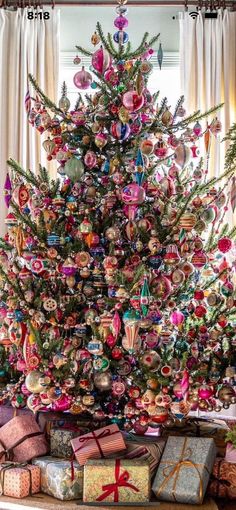 a decorated christmas tree with presents under it