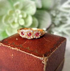 Vintage 18ct Gold, Ruby & Diamond Ring.  Hallmarked London 1983, Makers Mark J&P Size O (EU 56, US 7.5). Free Resizing Available - please message or email info@sobellejewellery.com Weight: 3.9g Rubies: 3 x 2mm Diamonds: 22 x 1mm Condition:  Good, clean vintage condition. All items will have a full professional clean and polish upon dispatch.  My items are all vintage so please study the photographs where I try to show as much detail as possible. Any damage or obvious imperfections will be clearl Heirloom Yellow Gold Multi-stone Diamond Ring, Heirloom Yellow Gold Cluster Ring With Gemstone, Classic Ruby Ring With Rose Cut Diamond Cluster, Victorian Multi-stone Yellow Gold Diamond Ring, Heirloom Yellow Gold Cluster Ring With Multi-stone, Luxury Cluster Ruby Ring Gift, Hallmarked Yellow Gold Ruby Ring For Wedding, Yellow Gold Hallmarked Ruby Ring For Wedding, Victorian Yellow Gold Birthstone Ring With Gemstone