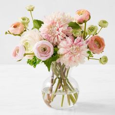 a vase filled with pink and white flowers