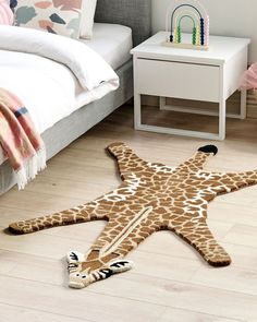 a giraffe print starfish rug on the floor in a child's bedroom