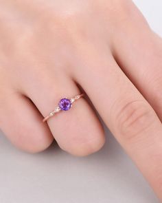 A 5mm round Cut Natural Amethyst ring Accent stone: white CZ The stones of the ring can be replace with other different kinds of gemstone such as morganite, aquamarine, amethyst, citrine, white CZ, pink CZ,etc. If you want to customize your own personal ring, please feel free to contact with me. (925 sterling silver white/yellow/rose gold plated or solid 14k white/yellow/rose gold are available) 14 days money back guarantee. Black Obsidian Ring, Unique Engagement Rings Rose Gold, Amethyst Engagement Ring, Rose Gold Plated Ring, Gold Jewelry Gift, Amethyst Ring Engagement, Faceted Ring, Purple Amethyst Ring, Engagement Rings Round