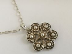 Unique handwork necklace from Bulgaria of 1930s, a little flower on chain. Made in traditional style with famous Bulgarian filigree, traditional Bulgarian jewelry. Made from the whute metal, possibly silver. Very delicate, slim and feminine item, real vintage. Size of the pendant is 2 cm, chain is 45 cm long. Excellent vintage condition. Vintage Jewelry With Flower Charm And Pendant, Vintage Necklaces With Flower Charm Round Pendant, Vintage Necklace With Flower Charm Round Pendant, Vintage Necklace With Round Pendant And Flower Charm, Vintage Pendant Necklace With Flower Charm, Vintage Flower Charm Pendant Jewelry, Vintage Flower-shaped Nickel-free Necklaces, Vintage Silver Flower-shaped Necklace, Vintage Silver Flower Shaped Necklace