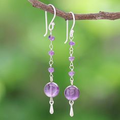 Matta in Thailand uses smooth purple gems to hand craft her lovely pair of dangle earrings. The artisan begins with a large amethyst orb which swings from a column of faceted amethyst gems. A silver-plated brass bead dangles below the orb while sterling silver hooks accents add shine and opulence. Chain Earrings Dangle Diy, Dangly Purple Earrings, Purple Round Spiritual Earrings, Spiritual Round Purple Earrings, Spiritual Purple Round Earrings, Lavender Nickel-free Dangle Jewelry, Purple Long Drop Earrings With Ear Wire, Nickel-free Lavender Dangle Jewelry, Amethyst Dangle Earrings For Jewelry Making