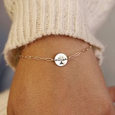 Sterling silver Tree of Life Hand stamped personalized disc bracelet with a sterling silver chain is uniquely hand crafted for you in Melt'm Jewelry Studio in Redlands, California. Handmade from high-quality Sterling Silver. This bracelet features a cute custom disc that hand stamped with a tree of life. It makes a thoughtful and heartfelt gift for moms, grandmothers, sisters, friends, and more. * Sterling silver disc is 9.5mm diameter. * Tree of Life stamped by hand. * Smooth finish, hammered o Dainty Customizable Silver Bracelet, Customizable Sterling Silver Charm Bracelet Gift, Personalized Sterling Silver Charm Bracelet As Gift, Customizable Silver Charm Bracelet, Personalized Dainty Sterling Silver Chain Bracelet, Handmade Charm Bracelet As Personalized Gift, Handmade Charm Bracelet For Personalized Gifts, Customizable Silver Name Bracelet, Personalized Sterling Silver Meaningful Bracelets