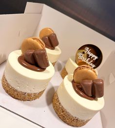 three desserts in a white box with chocolate and marshmallow toppings on top