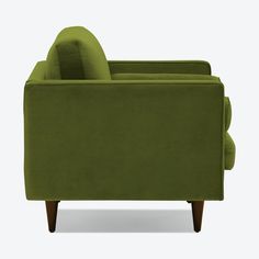 a green couch sitting on top of a white floor