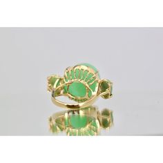 This is part of Chairish’s Fine Jewelry assortment.  18K Bullet Chalcedony and Jade 3 Stone Ring in Yellow Gold  This gorgeous 18K Bullet Chalcedony and Jade 3 Stone Ring in Yellow Gold is unique and you will not see another one. This ring is 19.31 high and deep and 17.67 round.  Furthermore, the Jade stones are approximately 0.75 carats each with a weight of 14.5 grams.  Bullet stones are very rare especially in this size. Do not wait. Elegant Green Gemstones In 14k Gold, Elegant Green Opal Ring In 14k Gold, Elegant Green Cabochon Emerald Ring, Elegant Green Emerald Cabochon Ring, Yellow Gold Jade Cabochon Ring, Luxury Gold Emerald Ring With Gemstone Accents, Luxury Emerald Ring With Gemstone Accents, Elegant Green Enamel Ring With Polished Finish, Elegant Green Opal Oval Ring