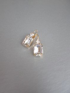 "These beautiful elegant earrings are made with fancy emerald cut and round Swarovski crystals. Available in gold, rose gold and silver finish. Matching necklaces an the bracelet are also available and they are shown in the last two photos. - 1 3/8\" long from the top of the ear wire to the bottom of the earring and 1/2\" wide - Leverback - For the matching bracelet please take a look here: https://www.etsy.com/listing/754440549/swarovski-crystal-bridal-bracelet-gold?ref=shop_home_active_19& Bridal Gold Earrings, Wedding Drop Earrings, Inexpensive Jewelry, Earrings Emerald, Gold Bridal Earrings, Wedding Earrings Drop, Matching Jewelry, Jewelry Lookbook, Earrings In Gold