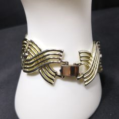 *Description: This is a great modernist bracelet by designer Bergere from the late 1940s to first half of the 1950s. The six links are gold tone with a silver tone base metal. The alligator clasp has Bergere on the back with no copyright symbol. Bergere was produced by L. Erbert & Pohls Inc. New York in 1947 through 1979. This modernist bracelet would be a great addition to your vintage jewelry collection or make a great vintage gift! *Approximate Measurements: Length - 7 1/4 Inches, Width - Elegant Metal Chain Bracelet With Box Clasp, Vintage Metal Chain Bracelet For Formal Occasions, Retro Yellow Gold Bracelet For Formal Occasions, Formal Jewelry With Box Clasp, Retro Brass Jewelry For Formal Occasions, Formal Metal Bracelets With Clasp, Gold Metal Bracelet With Clasp, Retro Yellow Gold Bracelets For Formal Occasions, Retro Bangle Bracelets For Formal Occasions