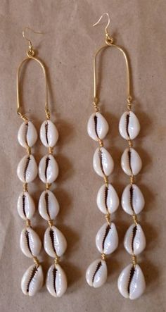 "Wholesale cowrie shell earrings are simple and light in weight.  Gift for loved ones and resellers. Simple and light in weight. Very comfy on any occasion. The earrings are made with a lot of love.  Listing for five pairs of earrings. Dimensions 7\" long Custom orders are welcome. For more earrings; https://www.etsy.com/listing/695802374/african-earrings-beaded-earrings-white?ref=shop_home_active_3 Dhl shipping express. Thankyou." Cowrie Shell Dangle Earrings As Gift, White Shell-shaped Cowrie Shell Earrings, White Cowrie Shell Earrings, White Cowrie Shell Earrings For The Beach, Bohemian White Cowrie Shell Earrings, Handmade White Shell, Handmade Shell Hoop Earrings, Handmade Hoop Earrings With Shell, Seashell Jewellery