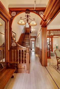 an ornate wooden staircase leads up to the second floor