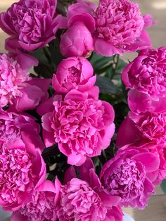 a vase filled with pink flowers on top of a table