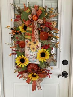 a door wreath with sunflowers and fall decorations