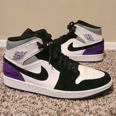 "The Air Jordan 1 Mid Se 'Varsity Purple' Brings An Elevated Look To Its Classic Basketball Design. Built With A White Leather Base, The Upper Is Overlaid By Black Suede At The Forefoot, With Varsity Purple Suede On The Heel. Pink Accents The Tongue, While Perforations On The Toe Box Provide Breathability. An Air Midsole Underfoot Provides Cushioning, Giving Way To A Varsity Purple Rubber Outsole With A Concentric Traction Pattern." 852542 105 | White/Black/Light Solar Flare Heather/Varsity Purple Black And Purple Air Jordans, Air Jordan 1 Mid Se, Basketball Design, Solar Flare, Purple Suede, Air Jordan 1 Mid, Jordan 1 Mid, Air Jordan 1, Mens Shoes Sneakers