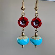 "Turquoise and Red Earrings - Blue Turquoise with Bronze Czech Glass Rondelle Beads dangle from Dark Red Czech Glass Flower Beads. Antiqued Brass Earwires Earrings measure just over 2\" from top of earwires to bottom of beads." Adjustable Multicolor Earrings With Flower Charm, Adjustable Multicolor Flower Charm Earrings, Czech Glass Earrings With Flower Charm For Gift, Flower Charm Earrings With Czech Glass For Gift, Turquoise Bohemian Flower Earrings For Gift, Gift Earrings With Flower Charm And Czech Glass, Hypoallergenic Red Flower Earrings, Adjustable Turquoise Flower Earrings Gift, Handmade Turquoise Flower-shaped Earrings