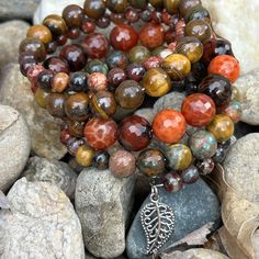 Earth tones of green, brown, red and orange define this 5 wrap boho bracelet.Genuine semi-precious stones featuring Tiger's Eye, Jasper, and Crackle Agate make up this done-for-you stack. 4mm round jasper 8mm Tiger's Eye 10mm faceted Crackle Agate one size fits most - best for small to medium wrists Handmade in Lincoln, Nebraska Artisan Hand Wrapped Wrap Bracelet With Round Beads, Multicolor Hand-strung Spiritual Wrap Bracelet, Handmade Wrap Bracelet With Round Beads For Healing, Unique Multicolor Wrap Bracelet For Healing, Spiritual Multicolor Hand-strung Wrap Bracelet, Hippie Beaded Bracelets With Natural Stones For Healing, Bohemian Carnelian Bracelets With Round Beads, Spiritual 8mm Beads Wrap Bracelet For Healing, Bohemian Brown Beaded Bracelets With Gemstones