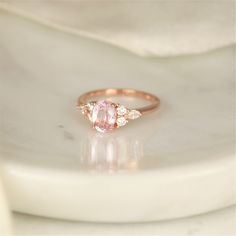 Our Thea ring here would make a great addition to any jewelry collection with her one of a kind center stone that is sure to wow the crowd! #rings #engagementrings #weddignrings #promiserings #selftreat #rosadosbox #rosegold #blush #champagne #sapphire #gemstone #diamonds #artdeco #cluster #oval #jewelry #finejewelry #gifts Rose Gold Oval Sapphire Ring With Brilliant Cut, Classic Oval Morganite Diamond Ring, Rose Gold Sapphire Ring With Diamond, Oval Cut, Oval Rose Gold Sapphire Ring With Diamond, Rose Gold Oval Sapphire Ring, Oval Rose Gold Sapphire Ring, Oval Morganite Wedding Ring With Brilliant Cut, Oval Sapphire Ring In Rose Gold With Diamonds, Oval Morganite Diamond Ring For Wedding