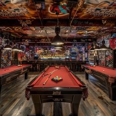 a pool table in a room with lots of graffiti on the walls and flooring