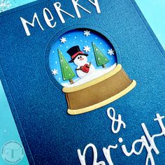 a christmas card with a snowman in a hat and trees under a glass dome