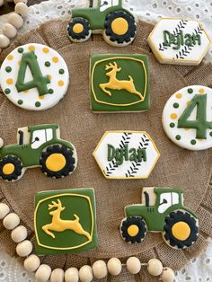 decorated cookies are arranged on a plate with tractor and number 4 in the middle, along with other decorations