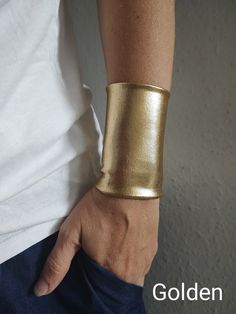 "Wide fabric wrist cuff bracelet in gold - visit my shop for more colors. Handbands, wrist cuffs, wrist wraps - visit my shop for more color matching accessories *Handmade with love and care in a smoke free home *Every wrist cuff is sewn by me *Double layered *Ideal for covering wrist tattoos *Stretchy and soft poliester *Fabulous accessory for your outfit *Goes well with everything *Unique and standing out COLOR: gold - other colors available in the drop down menu MATERIALS: poliester spandex w Wrist Cuff Bracelet, Wrist Cuff Jewelry, Golden Cuff Bracelet, Cuff Bracelet Gift, Adjustable Wearable Art Cuff Bracelet For Parties, Adjustable Cuff Bracelet For Party, Cuff Bracelets With Wrist Strap For Gift, Handmade Gold Leather Bangle Bracelet, Gold Adjustable Wristlet For Party