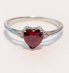 VALENTINES GIFT STERLING SILVER HEART ENGAGEMENT RING GARNET HEART  Face Height: 7 mm Band Width: 2 mm Stone: Garnet / Clear CZ post out in a free little gift box  nb;  Garnet is synthetic but very beautiful Red Heart Ring, Valentines Promise Ring, White Gold Ruby Ring, Ruby Heart Ring, Heart Engagement, Silver Promise Rings, Garnet Ring Silver, Garnet Heart, Dark Jewelry