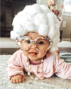 a baby wearing glasses and a white wig