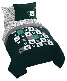 a bed in a room with green and white comforter sets on top of it