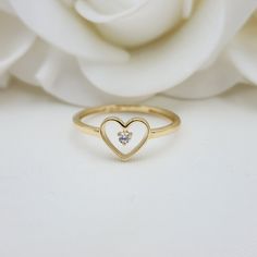 Our Adorable solid Gold Heart Solitaire CZ ring is crafted in Solid 14k Gold which makes it perfect to wear everyday and in every occasion.this ring is simple yet perfect. Unique, elegant and everlasting. 14k Gold will not tarnish or rust. Materials: 14k Gold, CZ Diamonds Stone size: 2mm Heart size: 8x7mm Band width: 1.5mm Weight: 1.3 grams 14k stamped  Brand new Follow us in our social media for more solid 14k Gold Jewelry. Please. Do not hesitate to contact me i will be happy to answer all you 14k Gold Solitaire Heart Ring For Promise, Minimalist White Heart Ring For Anniversary, Heart-shaped Single Diamond Ring Gift, Heart Shaped Single Diamond Ring For Gift, Heart Shaped Single Diamond Gift Ring, Heart-shaped Single Diamond Gift Ring, 14k Gold Heart Ring With Single Diamond For Gift, Minimalist Solitaire Heart Ring For Anniversary, Stackable Heart Ring For Everyday And Valentine's Day