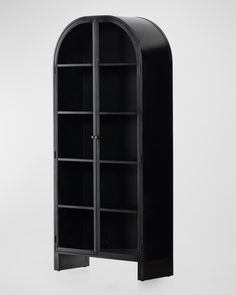 a black bookcase with an arched door and shelves on both sides, against a white background